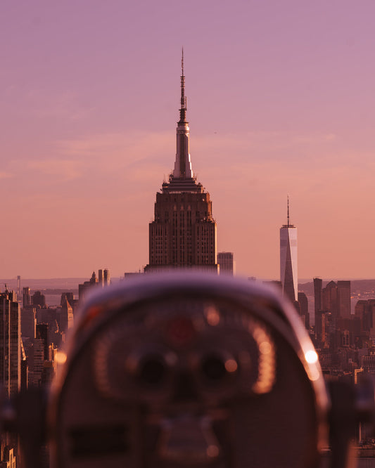 A viewfinder in the foreground with the top of the Empire State Building behind it