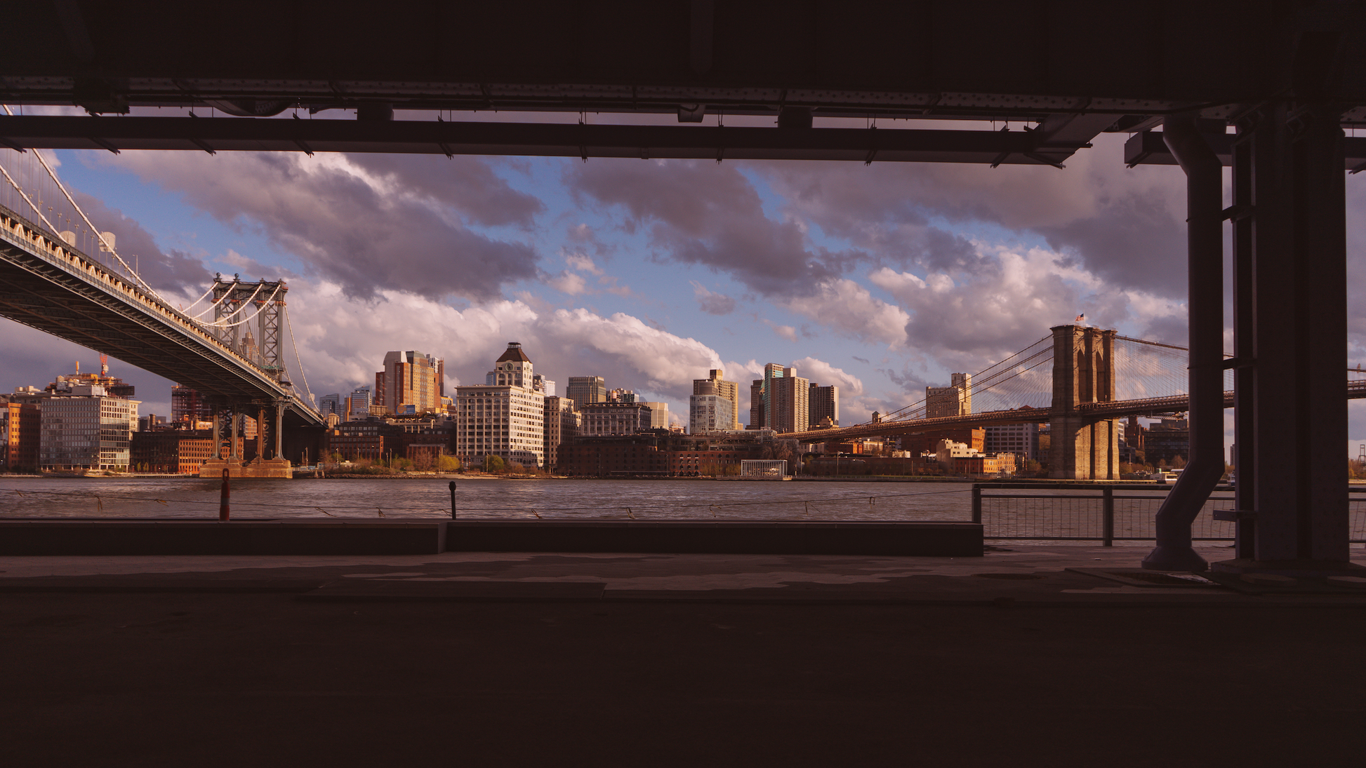 Both the Manhattan and Brooklyn Bridges as seen from under an overpass in NYC